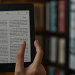 Kindle e-reader displaying paper-like reading interface with extensive digital book library and annotation capabilities