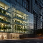 Futuristic building with visible adaptive facade elements responding to environmental conditions and occupant movement patterns