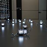 Swarm Intelligence demonstration showing multiple simple robots coordinating to solve complex problem through decentralized decision-making