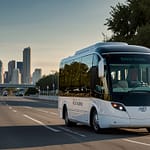 Modern autonomous shuttle hub with self-driving transit vehicles, passenger mobility systems, and urban automation technology